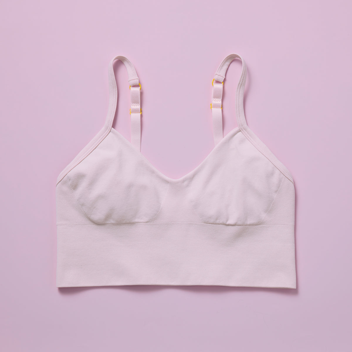 Light-colored bra on a pink background