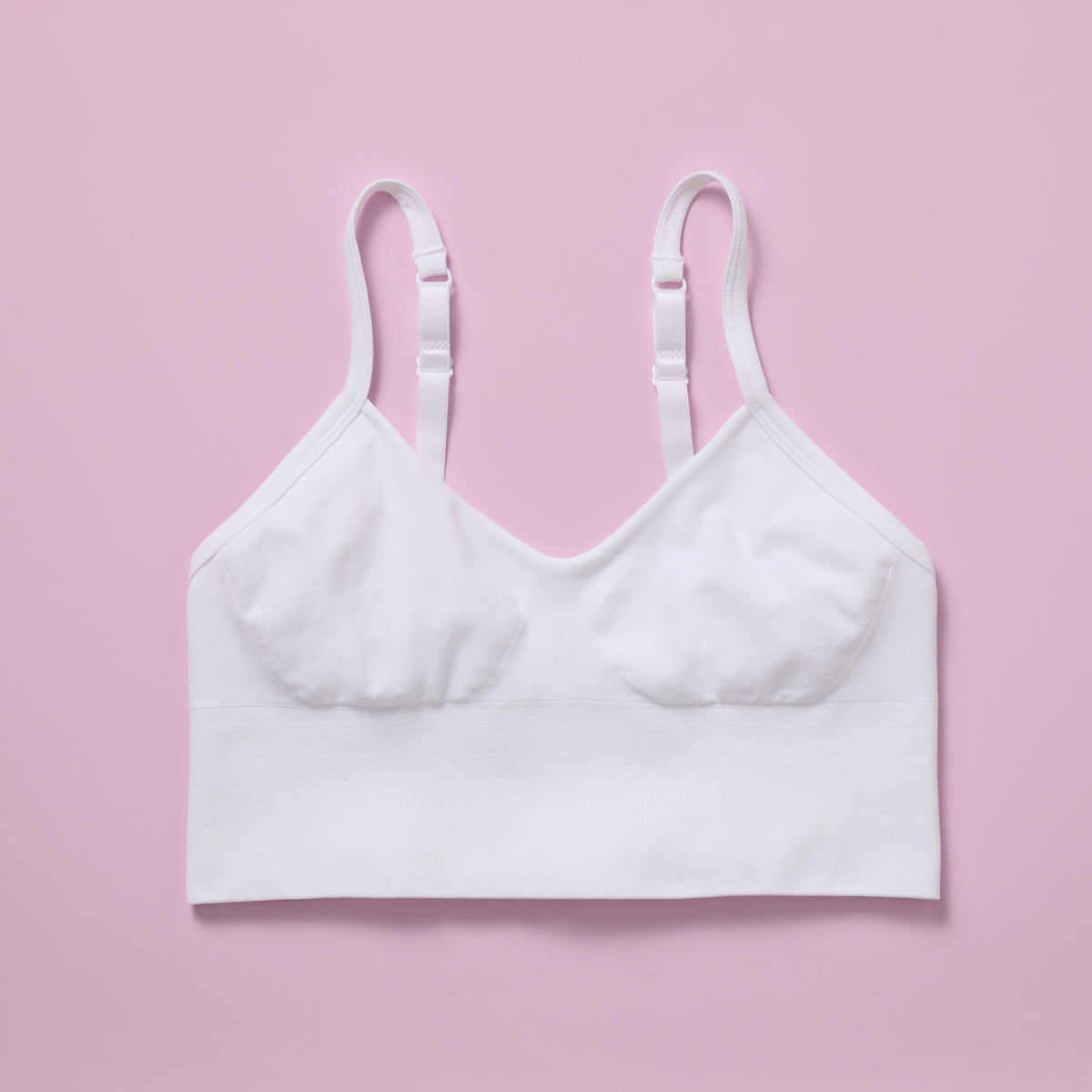 White bra on a pink background