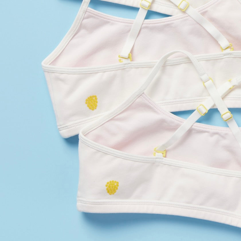 Yellowberry 3PK Bundle of Ladybug Marshmallow on blue background showing white bras closeup with pale pink lining and yellow accents