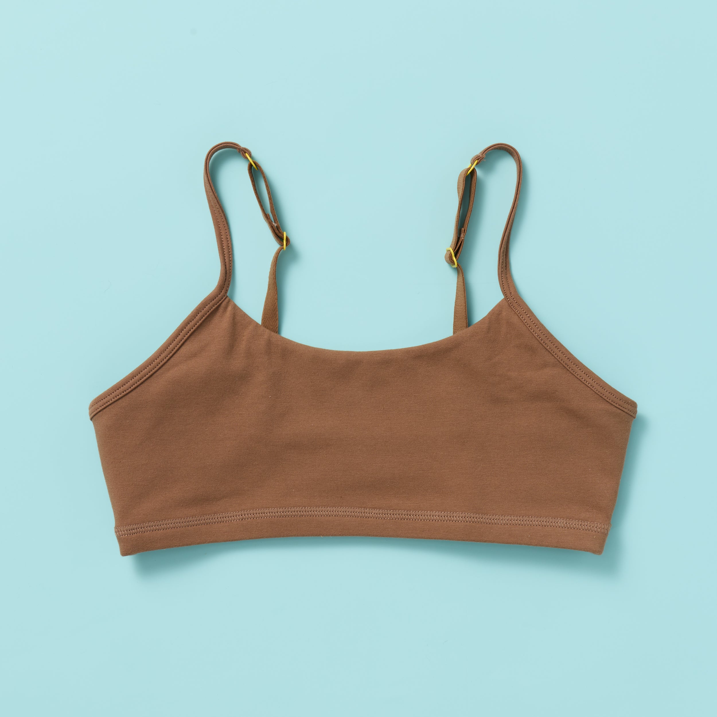Yellowberry Ladybug Brown cotton bralette on a light blue background