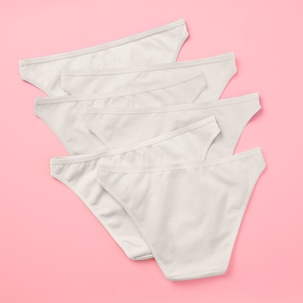 Yellowberry Petal Pima Cotton Bikini Underwear Bundle has a fuller coverage bottom. Made from luxurious Pima Cotton infused with a hint of Spandex, these undies provide the perfect amount of stretch for ultimate comfort and flexibility. The elastic waistband ensures a snug yet gentle fit, while the easy care instructions make laundry day a breeze. Snowflake White 6PK on pink back