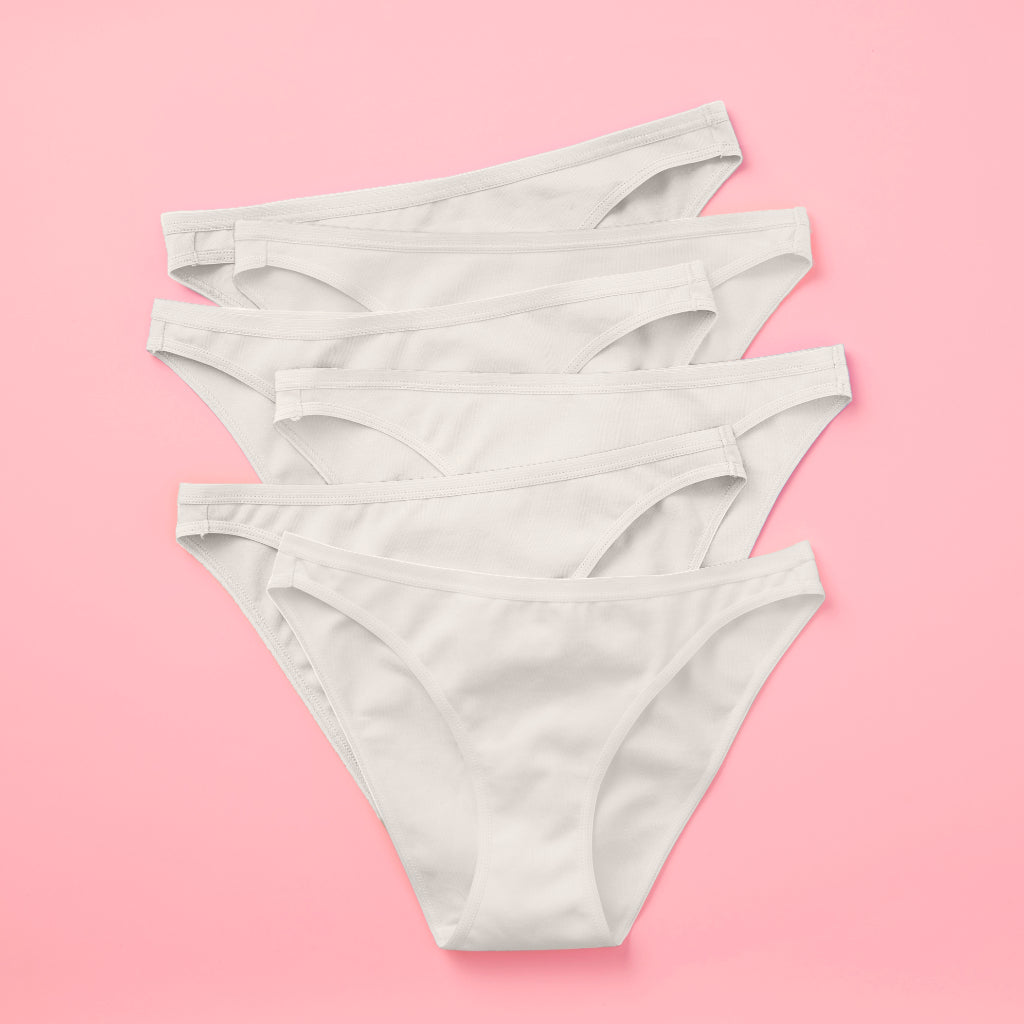 Yellowberry Petal Pima Cotton Bikini Underwear Bundle has a fuller coverage bottom. Made from luxurious Pima Cotton infused with a hint of Spandex, these undies provide the perfect amount of stretch for ultimate comfort and flexibility. The elastic waistband ensures a snug yet gentle fit, while the easy care instructions make laundry day a breeze. Snowflake White 6PK on pink front