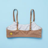 Yellowberry's beautiful pipit cotton training bra in the color mocha photographed as a laydown image of the back of the bra on a light blue background. This best-selling cotton style is super soft, all-natural cotton beginner bra. Supportive everyday bra with no underwires (ever!). High-quality, double-layered fabric. No padding. Designed for girls and daughters with sensitive skin. Machine wash, and dry. 