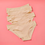 Yellowberry Simple Underwear In Doe Beige Front image on coral background bundle 6PK of Pima Cotton Underwear, designed with the utmost care and critique from moms and daughters far and wide. With a full coverage bottom and soft cotton construction, this underwear is high quality and great all day comfort.