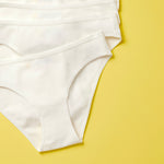 Yellowberry Simple Underwear In Snowflake White close up detail image on yellow background bundle 6PK of Pima Cotton Underwear, designed with the utmost care and critique from moms and daughters far and wide. With a full coverage bottom and soft cotton construction, this underwear is high quality and great all day comfort.