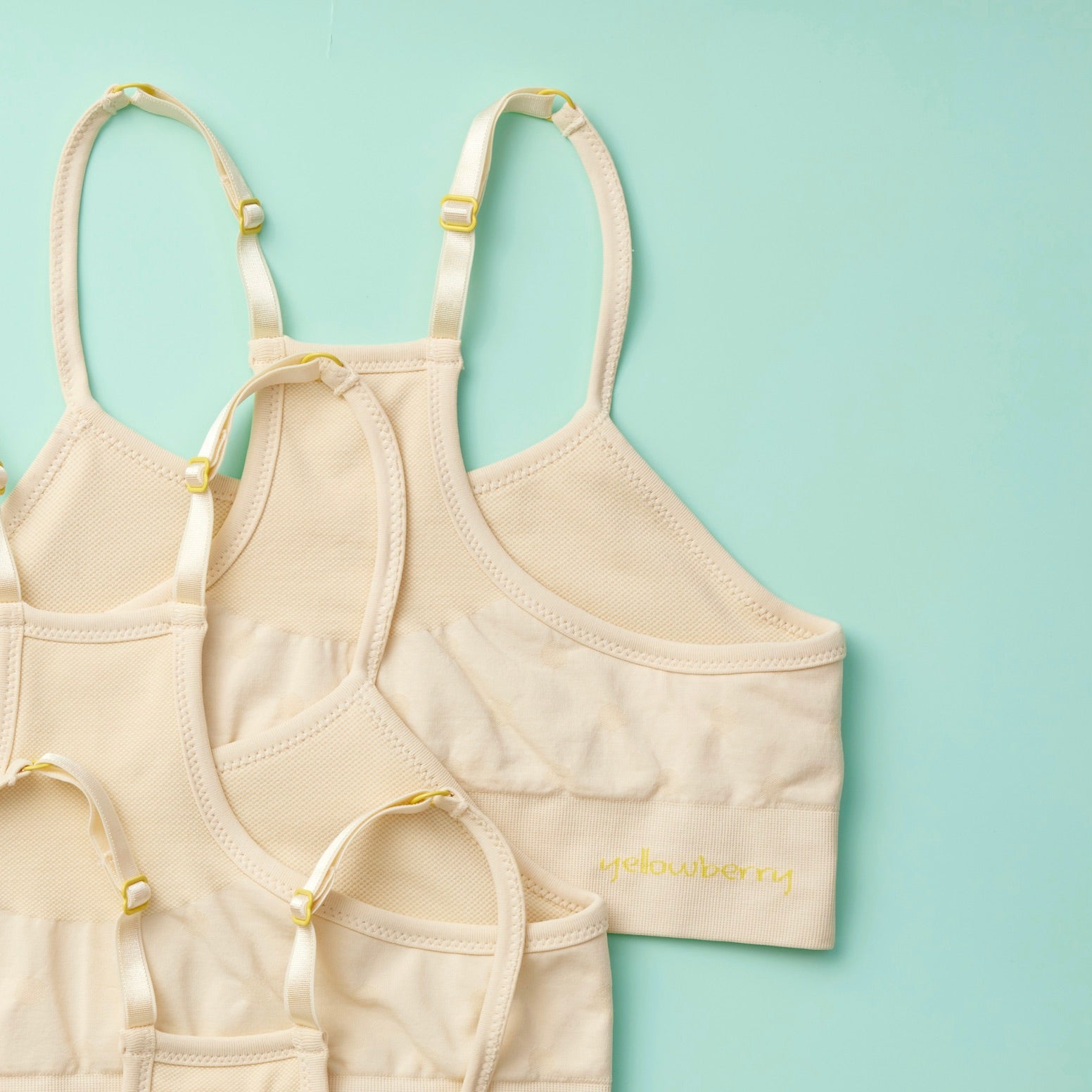 WIRE-FREE FREEDOM FOR EFFORTLESS WEAR: Experience wire-free freedom like never before with our Sugar Bra. Crafted with tweens and teens in mind, it's the ultimate choice for carefree, comfortable wear. Detail image 3PK Doe Beige on Mint  Green Background