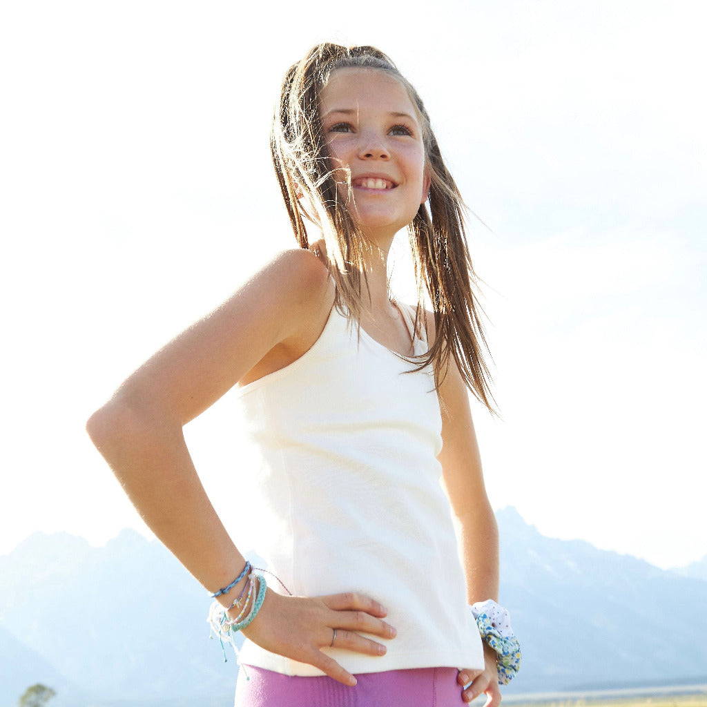 The Shell Camisole is our original for girls, by girls, premier tank top! Inspired by many girls who are not yet ready for a bra (or just want extra coverage), this cami features a built-in shelf bra making it an easy transition to the first bra. Overall, the Shell Cami is a snug, fitted tank designed with a suuuuper soft shelf bra. Great for girls with skin sensitivities as well due to the incredibly soft fabrics and features.