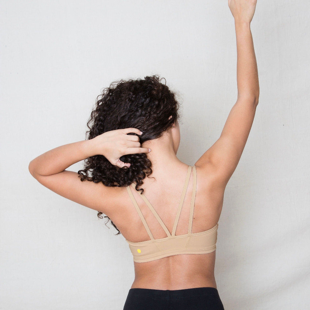 The Luna Bra is one of Yellowberry's original hybrid styles; built specifically for girls to move seamlessly from the classroom to practice. Coffee Bean on model. It's like two bras in one! Features like smooth fabric and full coverage make the Luna a popular choice for girls looking for bras they can wear all day, every day.