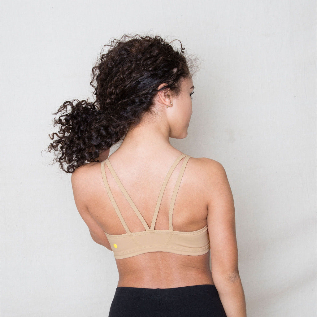 The Luna Bra is one of Yellowberry's original hybrid styles; built specifically for girls to move seamlessly from the classroom to practice. Coffee Bean on girl. It's like two bras in one! Features like smooth fabric and full coverage make the Luna a popular choice for girls looking for bras they can wear all day, every day.