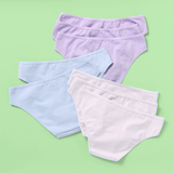 Eight pairs of women's bikini-style underwear in pastel shades of lavender, light blue, and white, arranged in a fan-like flat lay on a solid light green background.