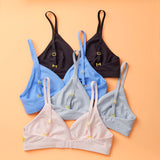 Yellowberry Butter Bra group of four colors (ocean, storm, starry nigiht, bubblegum) back laydown detail image. The BEST Bra We Make for More Developed Girls. Fabric is smooth to the touch and made with a matte brushed finish for extra softness. Made with synthetic fabric blend and hook and eye clasp closure. Great for developing girls. Wear and wash is over and over again, it will still look brand new. It will grow with your daughter as she continues to grow, great option for any occasion.