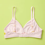 Yellowberry Butter Bra in bubblegum light pink, back laydown detail image. The BEST Bra We Make for More Developed Girls. Fabric is smooth to the touch and made with a matte brushed finish for extra softness. Made with synthetic fabric blend and hook and eye clasp closure. Great for developing girls. Wear and wash is over and over again, it will still look brand new. It will grow with your daughter as she continues to grow, great option for any occasion.