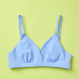 Yellowberry Butter Bra in ocean (a light blue), front laydown detail image. The BEST Bra We Make for More Developed Girls. Fabric is smooth to the touch and made with a matte brushed finish for extra softness. Made with synthetic fabric blend and hook and eye clasp closure. Great for developing girls. Wear and wash is over and over again, it will still look brand new. It will grow with your daughter as she continues to grow, great option for any occasion.