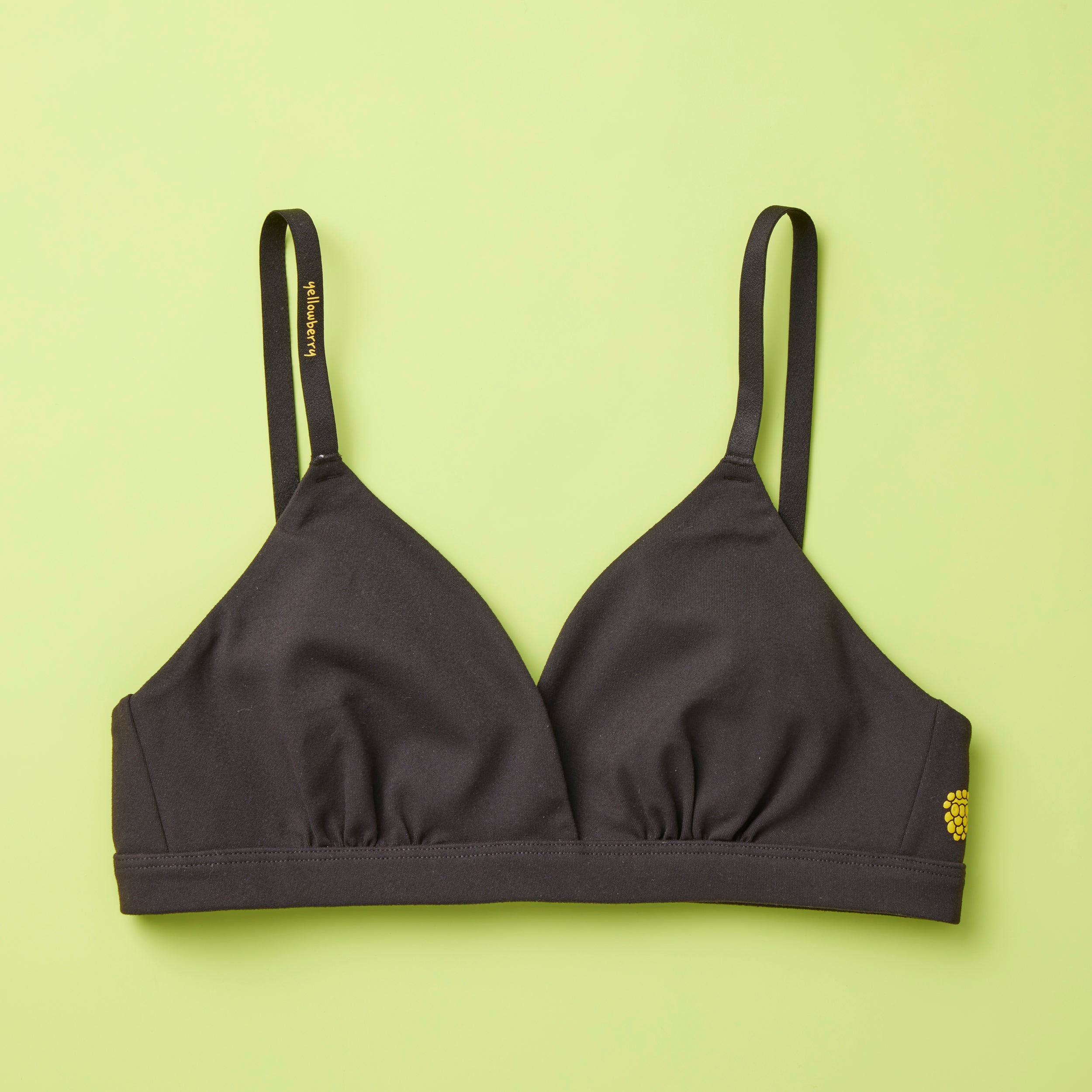 Yellowberry Butter Bra in starry night (black), front laydown detail image. The BEST Bra We Make for More Developed Girls. Fabric is smooth to the touch and made with a matte brushed finish for extra softness. Made with synthetic fabric blend and hook and eye clasp closure. Great for developing girls. Wear and wash is over and over again, it will still look brand new. It will grow with your daughter as she continues to grow, great option for any occasion.
