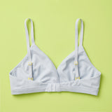 Yellowberry Butter Bra in storm (a light grey), back laydown detail image. The BEST Bra We Make for More Developed Girls. Fabric is smooth to the touch and made with a matte brushed finish for extra softness. Made with synthetic fabric blend and hook and eye clasp closure. Great for developing girls. Wear and wash is over and over again, it will still look brand new. It will grow with your daughter as she continues to grow, great option for any occasion.
