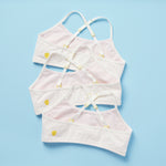 The original and first Yellowberry Ladybug Bra made specifically for first bra wearers. 3PK of Pima Cotton bras that offer great comfort and coverage. Three white bras with pale pink lining laydown back image on blue background.