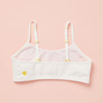 Back laydown detail image of best-selling Yellowberry Ladybug Bra in the color Marshmallow. The Absolute Best First Bra Ever Made. The Ladybug is our #1 best-selling bra for a reason. Built with a thicker, double layered cotton fabric, it ensures full coverage and support. All natural fabrics, incredibly soft. Anti microbial. Everyday bra for girls, tweens, and teens. Cotton fabric. Great for sensitive skin.