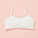 Front laydown detail image of best-selling Yellowberry Ladybug Bra in the color Marshmallow. The Absolute Best First Bra Ever Made. The Ladybug is our #1 best-selling bra for a reason. Built with a thicker, double layered cotton fabric, it ensures full coverage and support. All natural fabrics, incredibly soft. Anti microbial. Everyday bra for girls, tweens, and teens. Cotton fabric. Great for sensitive skin.