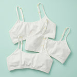 3PK of the original Yellowberry Training Bra for girls. Front Laydown image of three white bras on mint ground. The first bra that changed the industry of bras and underwear.