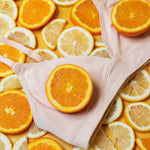The Yellowberry Triangle Full-Coverage bra is the ultimate choice for moms who want the best for their daughters at all stages of development. Front detal image of Lily Bra Doe color-way on oranges and lemons.