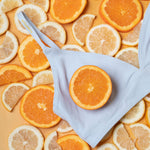 The Yellowberry Triangle Full-Coverage bra is the ultimate choice for moms who want the best for their daughters at every stage of development. Front close-up image of Lily Bra Raindrop colorway on oranges and lemons.