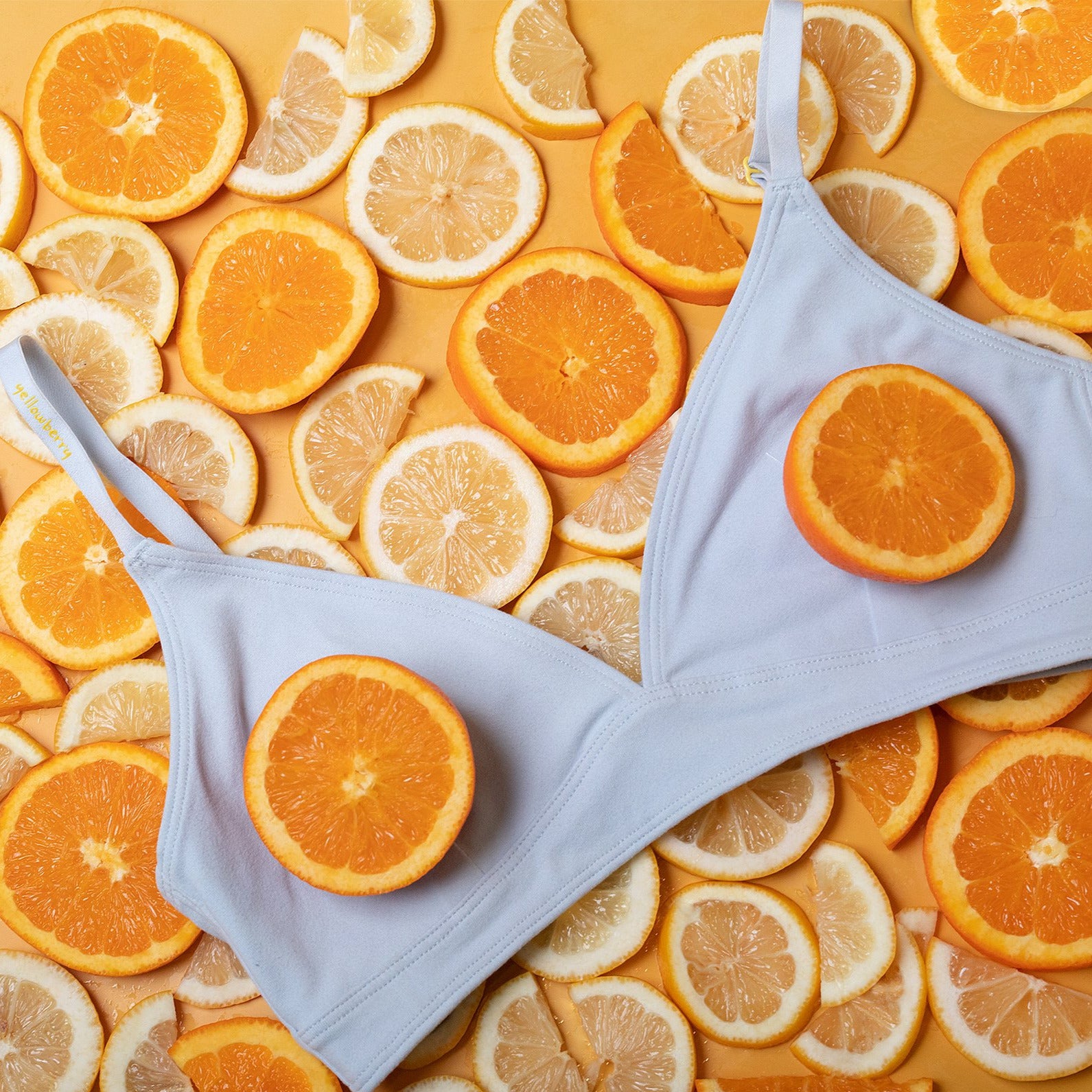 The Yellowberry Triangle Full-Coverage bra is a great choice for moms who want the best for their daughters in all stages of development. Front close-up image of Lily Bra Raindrop color-way on oranges and lemons.