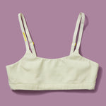 High-quality, all-natural, antimicrobial  Yellowberry Pipit First Training Bra. Super soft, all-natural cotton beginner bra. Supportive everyday bra with no underwires. High-quality, double-layered fabric. No padding. Designed with sensitive skin. Machine wash, and dry. Best teenager bra for active girls, tweens, and teens. The original female founded brand based in Jackson Hole.