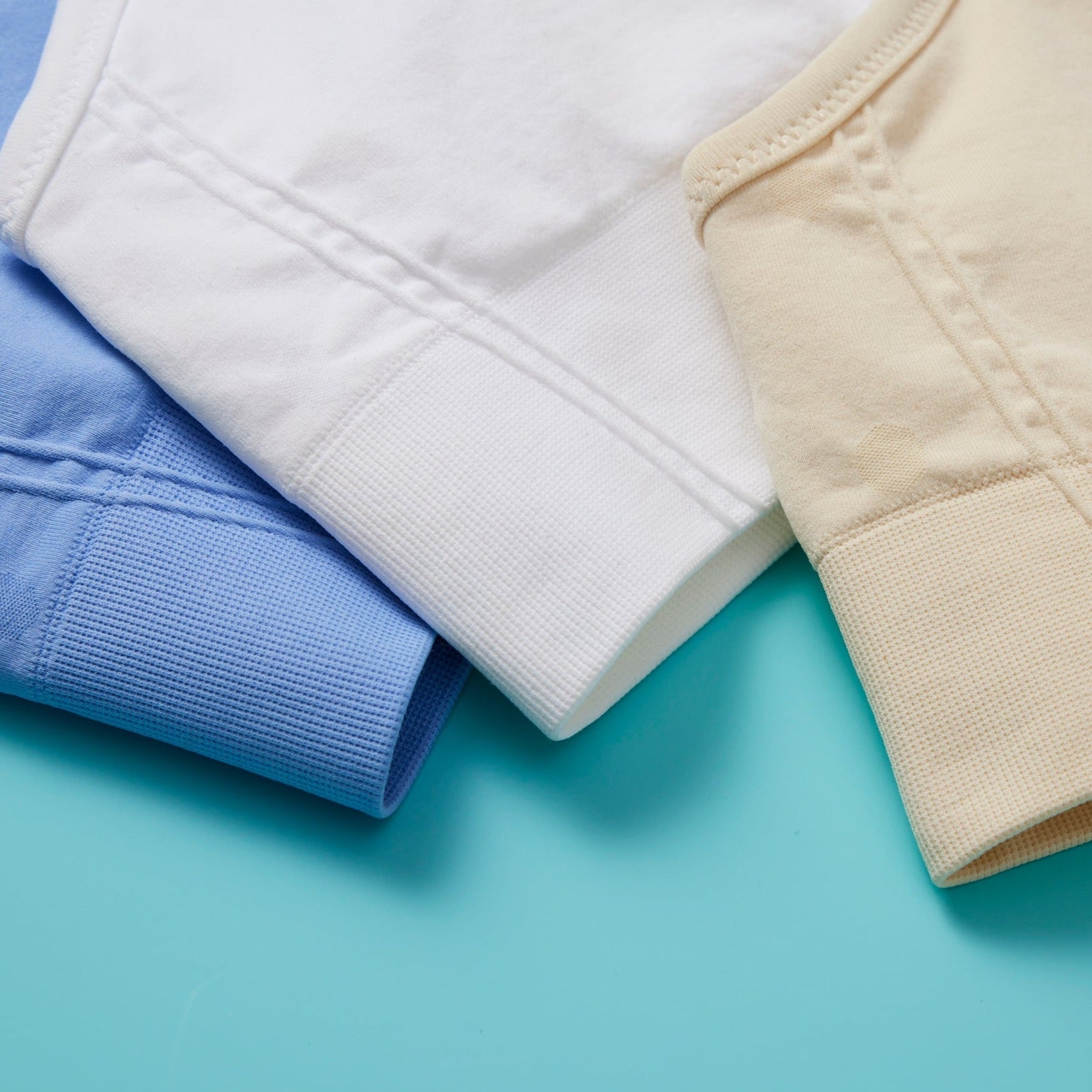 The Ultimate Seamless Racerback Girls Bra - Your Daughter's First Choice for Everyday Comfort! Are you searching for the perfect seamless bra for your growing girl? Look no further! Our girls' seamless racerback bra is meticulously designed with superior features to ensure unbeatable comfort and support, making it the ideal choice for her first bras and everyday wear. Multi detail of colors front image on mint green background.