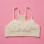 The Ultimate Seamless Racerback Girls Bra - Your Daughter's First Choice for Everyday Comfort! Are you searching for the perfect seamless bra for your growing girl? Look no further! Our girls' seamless racerback bra is meticulously designed with superior features to ensure unbeatable comfort and support, making it the ideal choice for her first bras and everyday wear. Doe front image on pink background.