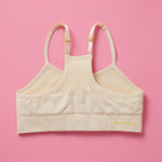 The Ultimate Seamless Racerback Girls Bra - Your Daughter's First Choice for Everyday Comfort! Are you searching for the perfect seamless bra for your growing girl? Look no further! Our girls' seamless racerback bra is meticulously designed with superior features to ensure unbeatable comfort and support, making it the ideal choice for her first bras and everyday wear. Doe Back image on pink background.