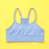 The Ultimate Seamless Racerback Girls Bra - Your Daughter's First Choice for Everyday Comfort! Are you searching for the perfect seamless bra for your growing girl? Look no further! Our girls' seamless racerback bra is meticulously designed with superior features to ensure unbeatable comfort and support, making it the ideal choice for her first bras and everyday wear. Ocean front image on yellow background.
