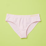 Yellowberry Twistr Seamless Underwear in Bubblegum (light pink color) on a green background. These underwear are true seamless, high quality girls underwear and made with super soft fabrics. Girl and mom approved!