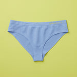 Yellowberry Twistr Seamless Underwear in Ocean (blue color) on a green background. These underwear are true seamless, high quality girls underwear and made with super soft fabrics. Girl and mom approved!