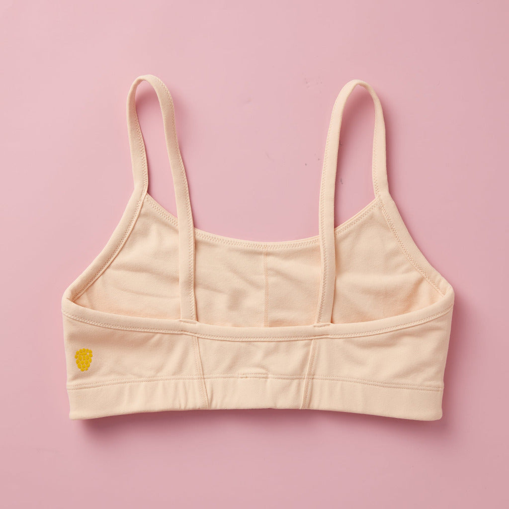 Styled detail image of Yellowberry Sky Bra in beige. The Sky Hybrid Sports Bra is double-layered and fully lined to ensure full coverage and medium to high support. Softest fabrics, AND made by a female founded company.