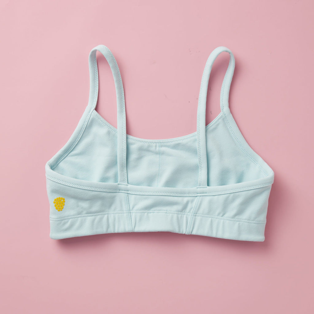 Styled detail image of Yellowberry Sky Bra in Pebble (light blue). The Sky Hybrid Sports Bra is double-layered and fully lined to ensure full coverage and medium to high support. Softest fabrics, AND made by a female founded company.