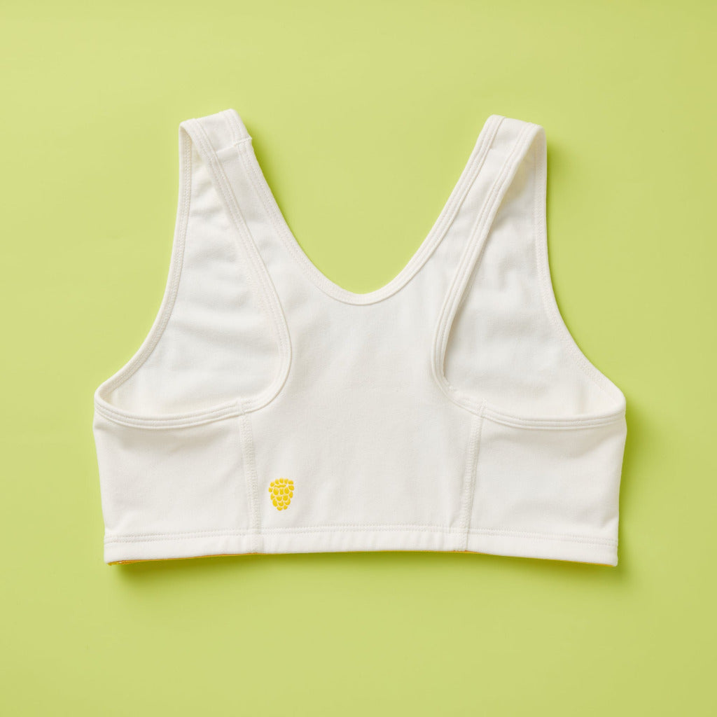 Half Moon Bra in white. The Yellowberry’s original sports bra. Newly redesigned and improved high-impact style. All natural fabrics. sweat-wicking, antimicrobial. Featuring a wider width racerback and buttery soft fabric. Great for sensitive skin.