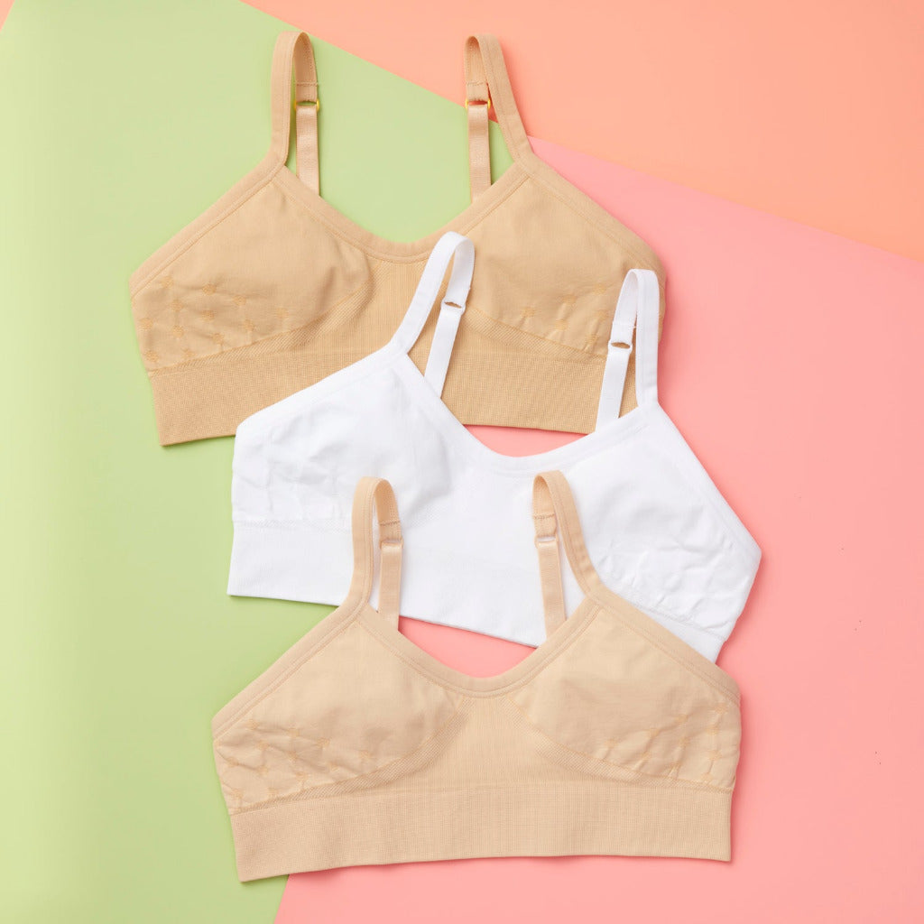 Our Seamless Poppy Bra bundles of three (white and beige colors) is sewn with extra soft, double layered, antimicrobial fabric. It offers great support as a training bra as well as for developing girls, teens, and tweens. Straps are convertible, straps are adjustable, and its quick-dry fabric is perfect for girls with skin sensitivities. Perfect everyday bra.