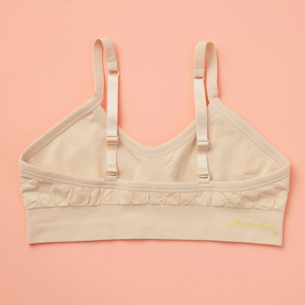 Our Seamless Poppy Bra is sewn with extra soft, double layered, antimicrobial fabric. It offers great support as a training bra as well as for developing girls, teens, and tweens. Straps are convertible, straps are adjustable, and its quick-dry fabric is perfect for girls with skin sensitivities. Perfect everyday bra.