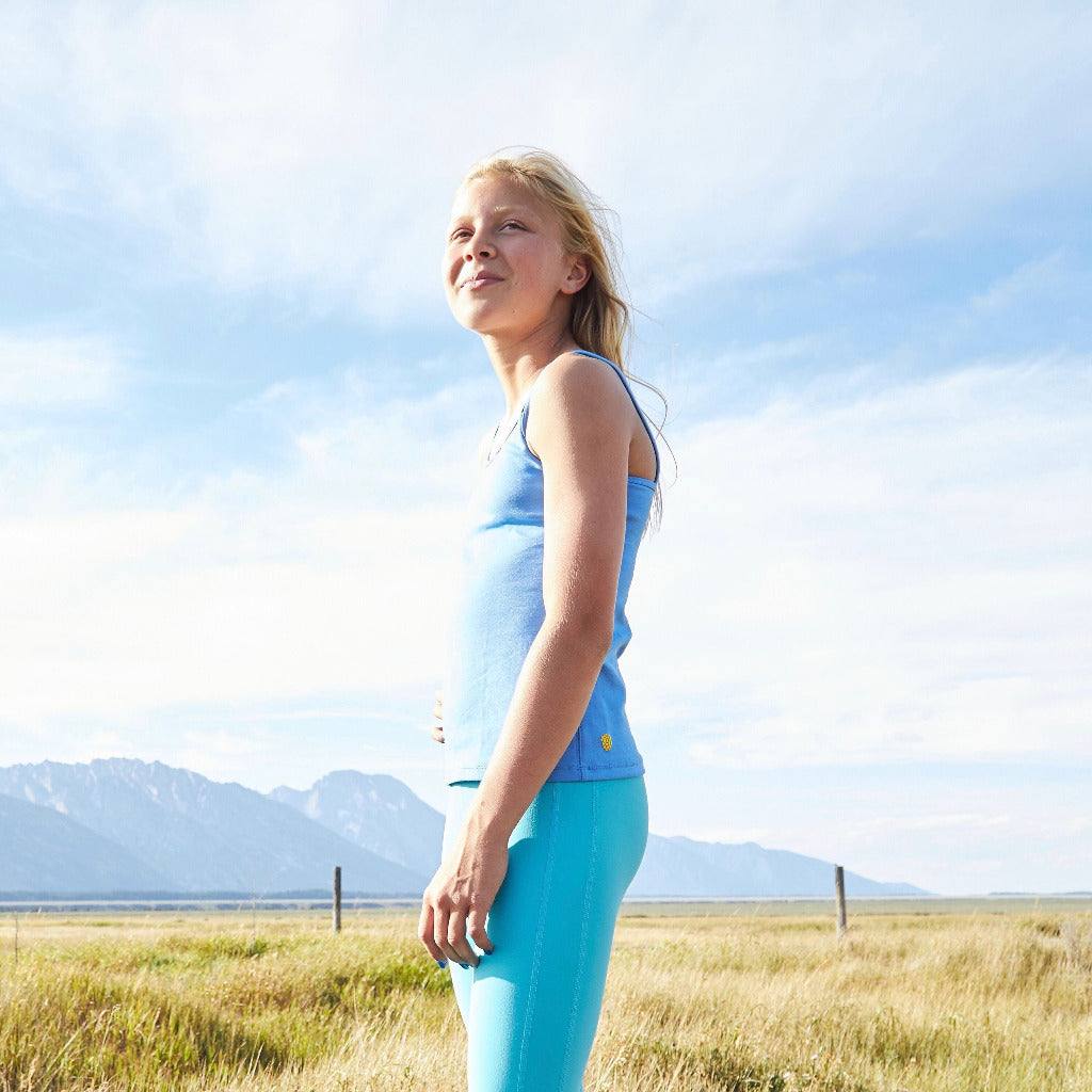 The Shell Camisole is our original for girls, by girls, premier tank top! Inspired by many girls who are not yet ready for a bra (or just want extra coverage), this cami features a built-in shelf bra making it an easy transition to the first bra. Overall, the Shell Cami is a snug, fitted tank designed with a suuuuper soft shelf bra. Great for girls with skin sensitivities as well due to the incredibly soft fabrics and features.