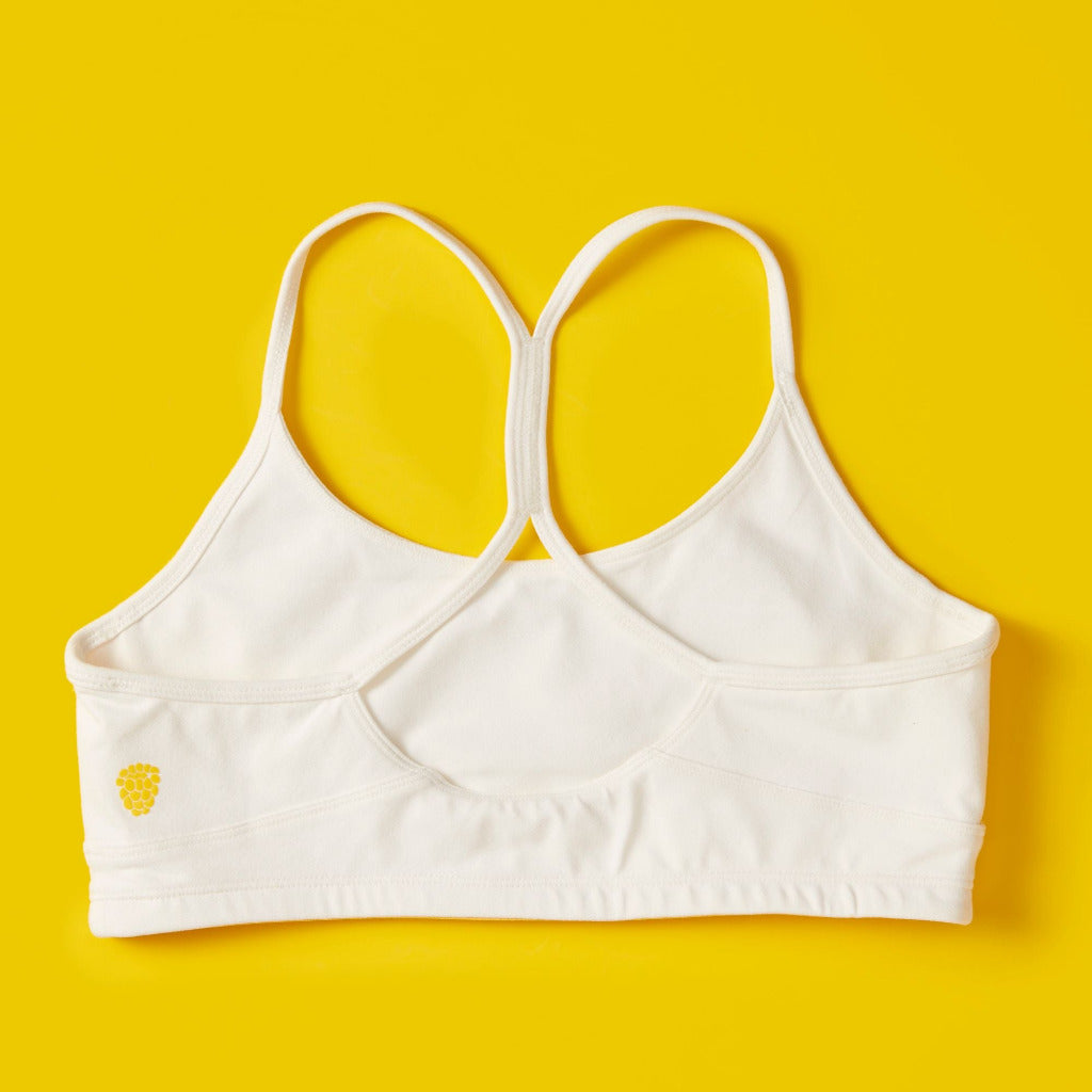 Front detail image of Yellowberry Tink Hybrid Sports Bra in white. Like two bras in one. Made with high quality, double-layered, antimicrobial, moisture wicking fabric. 