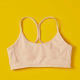 Front close detail image of Yellowberry Tink Hybrid Sports Bra in beige. Like two bras in one! Made with high-quality, double-layered, antimicrobial, moisture-wicking fabric. 