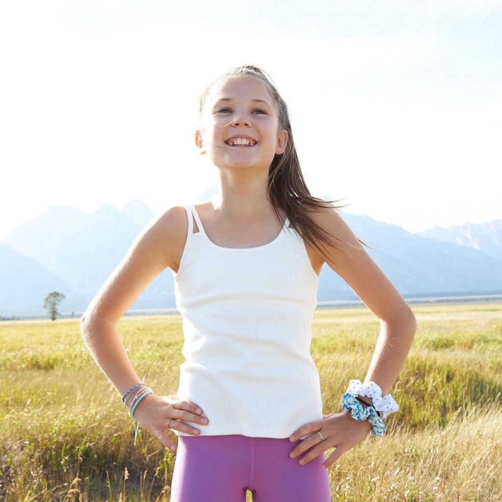 The Shell Camisole is our original for girls, by girls, premier tank top! Inspired by many girls who are not yet ready for a bra (or just want extra coverage), this cami features a built-in shelf bra making it an easy transition to the first bra. Overall, the Shell Cami is a snug, fitted tank designed with a suuuuper soft shelf bra. Great for girls with skin sensitivities as well due to the incredibly soft fabrics and features.