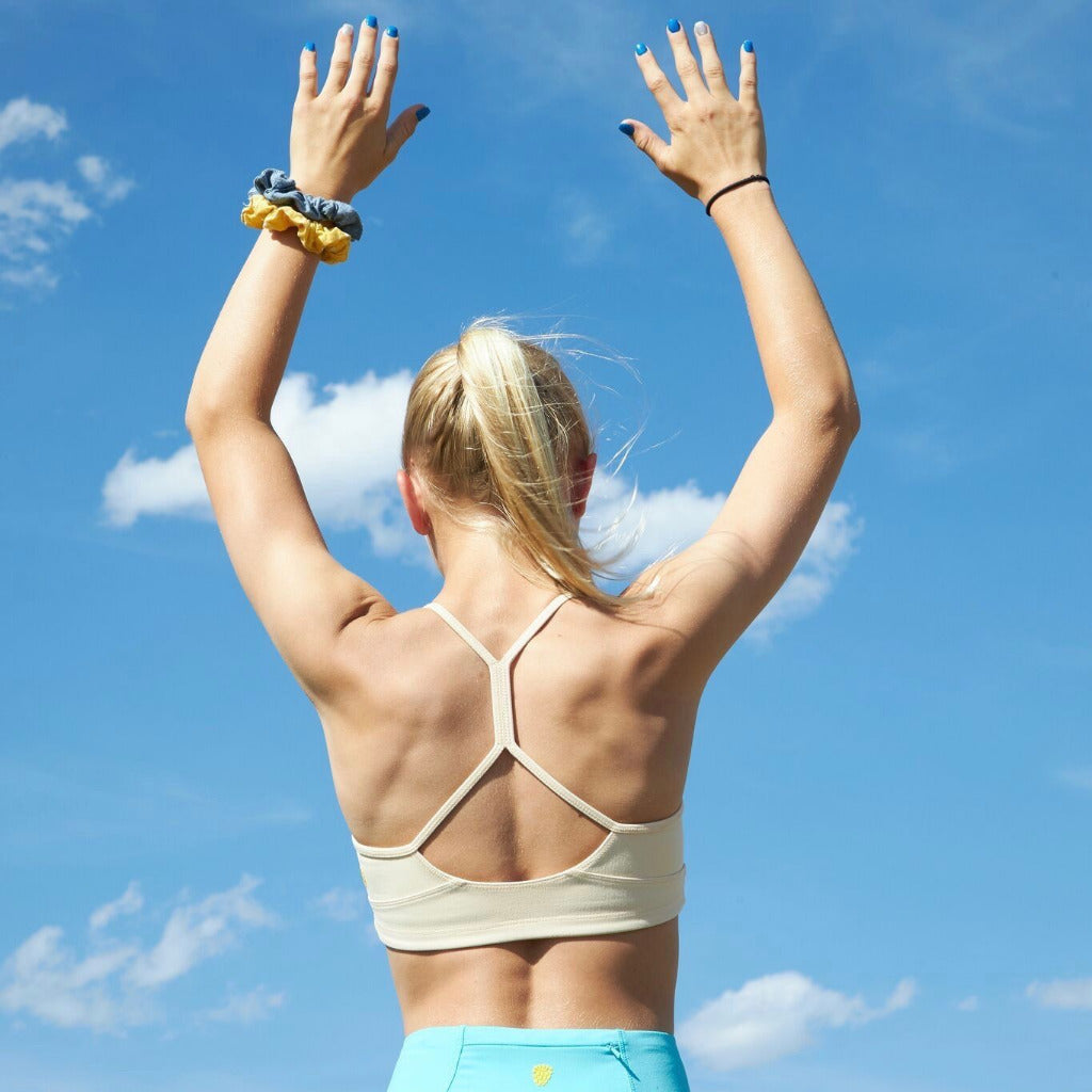 Yellowberry Tink Hybrid Sports Bra in beige. Like two bras in one! Made with high quality, double-layered, antimicrobial, moisture wicking fabric. Made for all high impact and light activity. High to medium support for girls. A Great training bra too. Created by a female founded, female owned company.