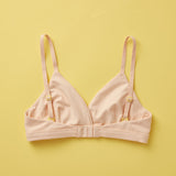 Yellowberry Butter Bra in beige, back laydown detail image. The BEST Bra We Make for More Developed Girls. Fabric is smooth to the touch and made with a matte brushed finish for extra softness. Made with synthetic fabric blend and hook and eye clasp closure. Great for developing girls. Wear and wash is over and over again, it will still look brand new. It will grow with your daughter as she continues to grow, great option for any occasion. Convertible straps. Adjustable straps.