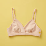 Yellowberry Butter Bra in beige, front laydown detail image. The BEST Bra We Make for More Developed Girls. Fabric is smooth to the touch and made with a matte brushed finish for extra softness. Made with synthetic fabric blend and hook and eye clasp closure. Great for developing girls. Wear and wash is over and over again, it will still look brand new. It will grow with your daughter as she continues to grow, great option for any occasion. Convertible straps. Adjustable straps.