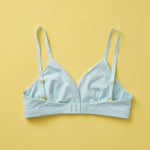 Yellowberry Butter Bra in light blue, back laydown image. The BEST Bra We Make for More Developed Girls. Fabric is smooth to the touch and made with a matte brushed finish for extra softness. Made with synthetic fabric blend and hook and eye clasp closure. Great for developing girls. Wear and wash is over and over again, it will still look brand new. It will grow with your daughter as she continues to grow, great option for any occasion.