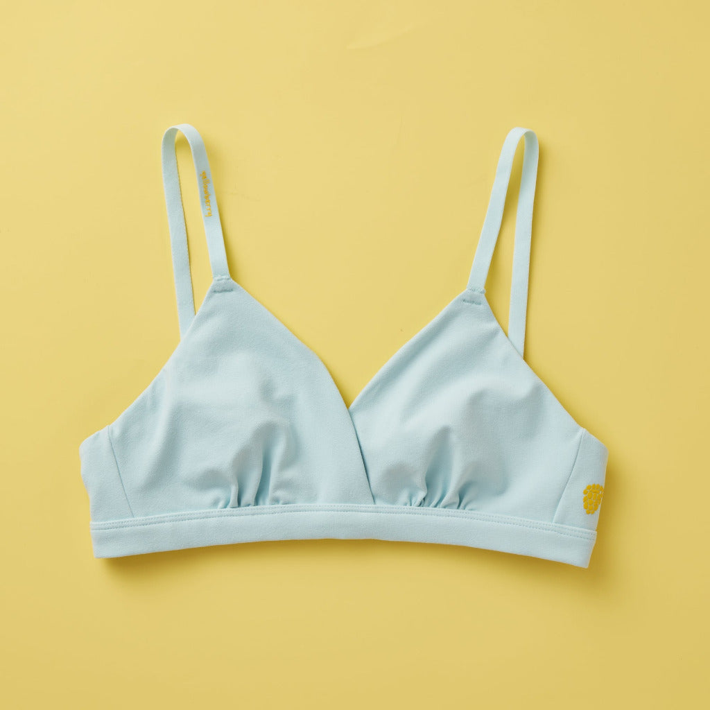 Yellowberry Butter Bra in light blue color, front laydown. The BEST Bra We Make for More Developed Girls. Fabric is smooth to the touch and made with a matte brushed finish for extra softness. Made with synthetic fabric blend and hook and eye clasp closure. Great for developing girls. Wear and wash is over and over again, it will still look brand new. It will grow with your daughter as she continues to grow, great option for any occasion.