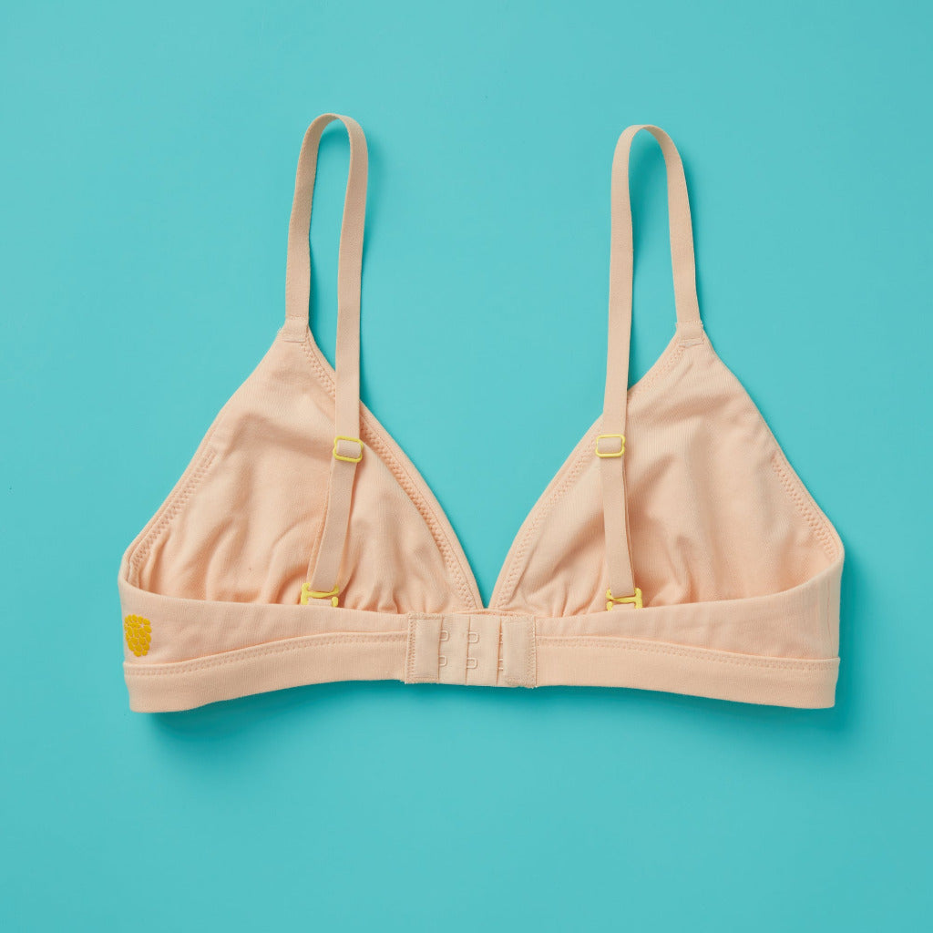 Yellowberry’s Joey Bra for Girls: A bra that grows with you. Made with double layered cotton-spandex fabric (great for sensitive skin!) just for girls beginning to develop. Back laydown beige.