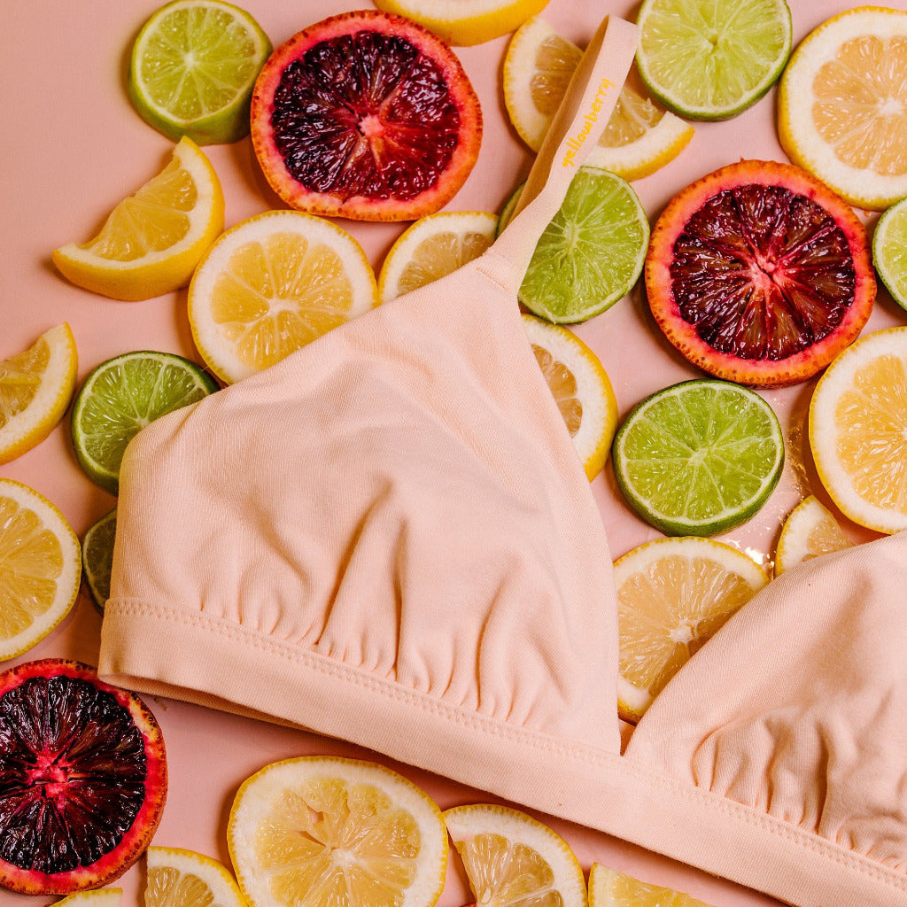 Yellowberry’s Joey Bra for Girls: A bra that grows with you. Made with double layered cotton-spandex fabric (great for sensitive skin!) just for girls beginning to develop. Styled with fruit, close up image.
