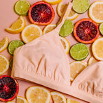 Yellowberry’s Joey Bra for Girls: A bra that grows with you. Made with double layered cotton-spandex fabric (great for sensitive skin!) just for girls beginning to develop. Styled with fruit, close up image.